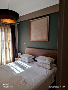 Postel nebo postele na pokoji v ubytování Ulysses Apartments Acropolis