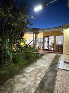 a home with a pathway leading to the front door at Casa de Campo en Salcoatitan in Salcoatitán