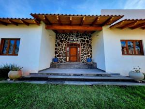 a house with a wooden door and stairs in front at Casa de campo Santa Elena in Huasca de Ocampo