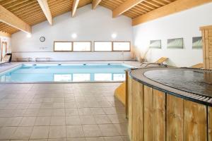 a large swimming pool in a building at Hameau 8 102 - SPA & PISCINE appartement 4 pers in Orelle