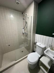 a bathroom with a shower and a toilet and a sink at 7 Senses Vista 1 BD Apartment in Gudauri