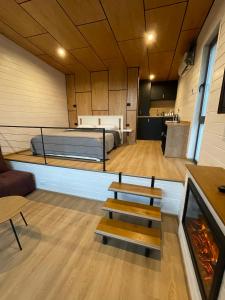 a room with a bed and a couch and a fireplace at NOIA Loft in Piatra Neamţ