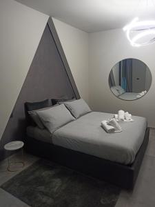 a bedroom with a large bed with a mirror at Le Mirage in Chieti