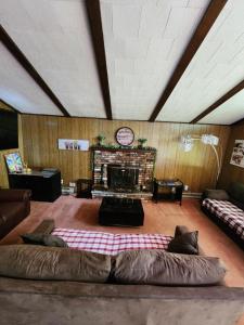 a living room with a large couch in front of a fireplace at Pecosa home in Bushkill