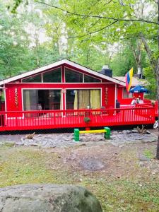 a red house with a large front porch at Pecosa home in Bushkill