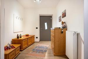 a kitchen with wooden cabinets and a refrigerator at Martina's Place in Castello di Fiemme