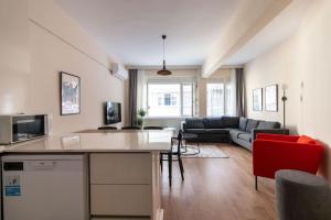 a kitchen and living room with a table and a couch at Spacious & Trendy 3BR Urban Home w/ ACs in Istanbul