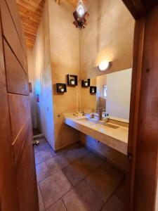 a bathroom with a sink and a large mirror at Casa de campo Santa Elena in Huasca de Ocampo