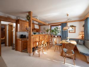 a kitchen and living room with a table and chairs at Chalet - Appartements Julitta in Mayrhofen