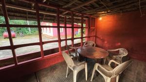a table and chairs in a room with a window at Rose villa in Meenangadi
