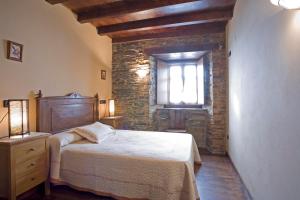 - une chambre avec un grand lit et une fenêtre dans l'établissement Balcón de Oscos, à Santa Eulalia de Oscos
