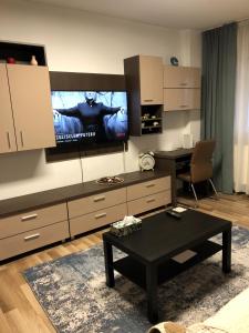 a living room with a tv and a coffee table at Adrian Home Mega in Ploieşti