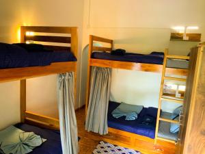 a room with three bunk beds in a room at Chill River Villa - Villa with Scenic River Views in Weligama