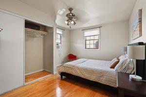 a bedroom with a bed and a ceiling fan at Private, Quiet 2BR in Central Culver City Parking in Los Angeles