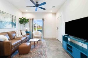 a living room with a couch and a flat screen tv at Jazz House*King Bed*Lux Matt*Coffee Bar in Lafayette