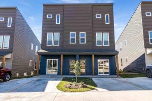 a large house with a car parked in a driveway at Jazz House*King Bed*Lux Matt*Coffee Bar in Lafayette