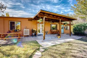 a small yellow house with a wooden roof at Rocking S Ranch in Cottonwood