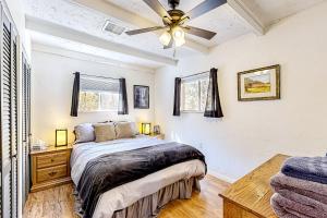 a bedroom with a bed and a ceiling fan at Rocking S Ranch in Cottonwood