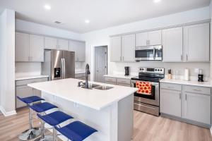a kitchen with white cabinets and a white counter top at Winners Paradise next to LSU in Baton Rouge