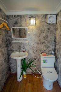 a bathroom with a sink and a toilet at Cana Garden 3 in Ban Khok