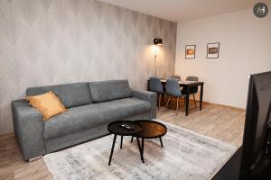 a living room with a couch and a table at AH Lomená in Košice