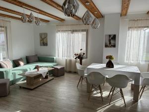 a living room with a green couch and a table at Vila Monica in Bran