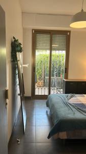 a bedroom with a bed and a large window at Bel appartement proche de la mer in Nice