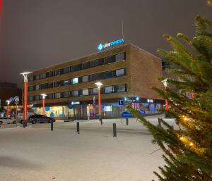 a building with a christmas tree in front of it at Arctic Escape in Rovaniemi