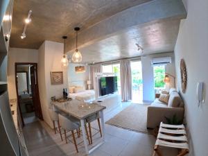 a living room with a couch and a table in a room at Lasuiza Suites in San Bernardino