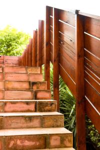 a set of wooden stairs next to a fence at 16 On Antrim in Hermanus