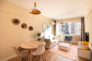 a living room with a table and a couch at Cozy & Complete 1BR Retreat w/ Balcony in Istanbul
