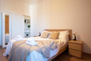 a bedroom with a bed with towels on it at I Host Apartment - Sant'Agostino 7 in Milan