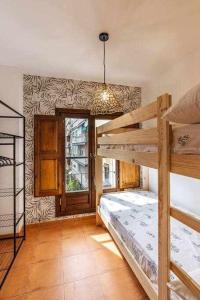 a bedroom with two bunk beds and a window at Alto house edificio completo in Granada