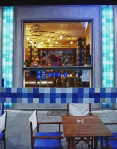 una mesa y bancos frente a un restaurante en Hostal Bezana, en Burgos