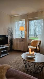 a living room with a coffee table and a tv at Åvillan - River house in Lagan