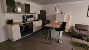 a small kitchen with a table and a couch at Monteurwohnung in Bad Neustadt an der Saale