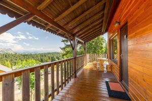 a deck with a view of the mountains at Chalet Les étoiles vue Mont Blanc in Pugny-Chatenod