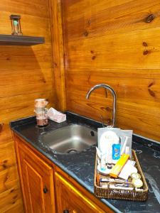 a kitchen counter with a sink in a room at منتجع ريف العلا in Al-ʿUla