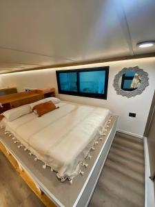 a large bed in the middle of a room at Tiny House By The Beach in Mazatlán