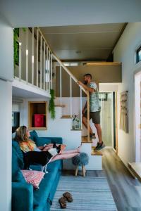 a group of people sitting on a couch in a living room at Tiny House By The Beach in Mazatlán