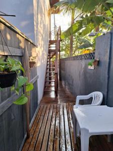 a wooden porch with a staircase and a stair case at Apartamento na Barra de Ibiraquera in Imbituba +13 photos