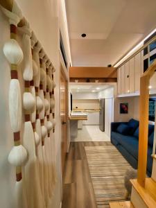 a room with a staircase leading to a living room at Tiny House By The Beach in Mazatlán