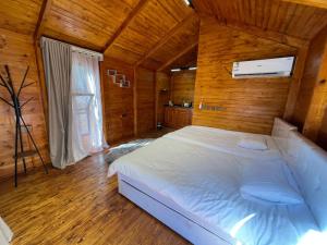 a bedroom with a large bed in a wooden room at منتجع ريف العلا in AlUla