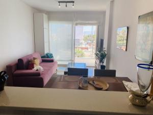 a living room with a couch and a table at Anacasa Albatros MET Oliva Nova Golf AP463 in Oliva