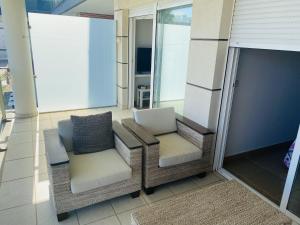 a balcony with two chairs and a table at Anacasa Albatros MET Oliva Nova Golf AP463 in Oliva