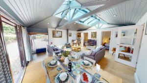 an aerial view of a living room with a table at Arniss Lodge in Fordingbridge