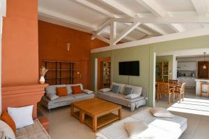 a living room with a couch and a table at Villa Terracotta - Stunning Sea View & Pool in Carqueiranne