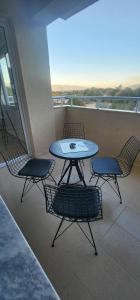 a table and chairs on top of a balcony at THE 21st SUITE in Strumica