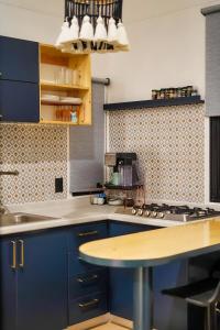 a kitchen with blue cabinets and a counter top at Tiny House By The Beach in Mazatlán