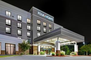 a front view of a hotel at night at Four Points by Sheraton Birmingham Homewood in Homewood